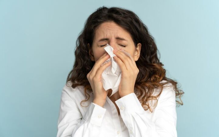 Person with seasonal allergy symptoms during a telehealth visit