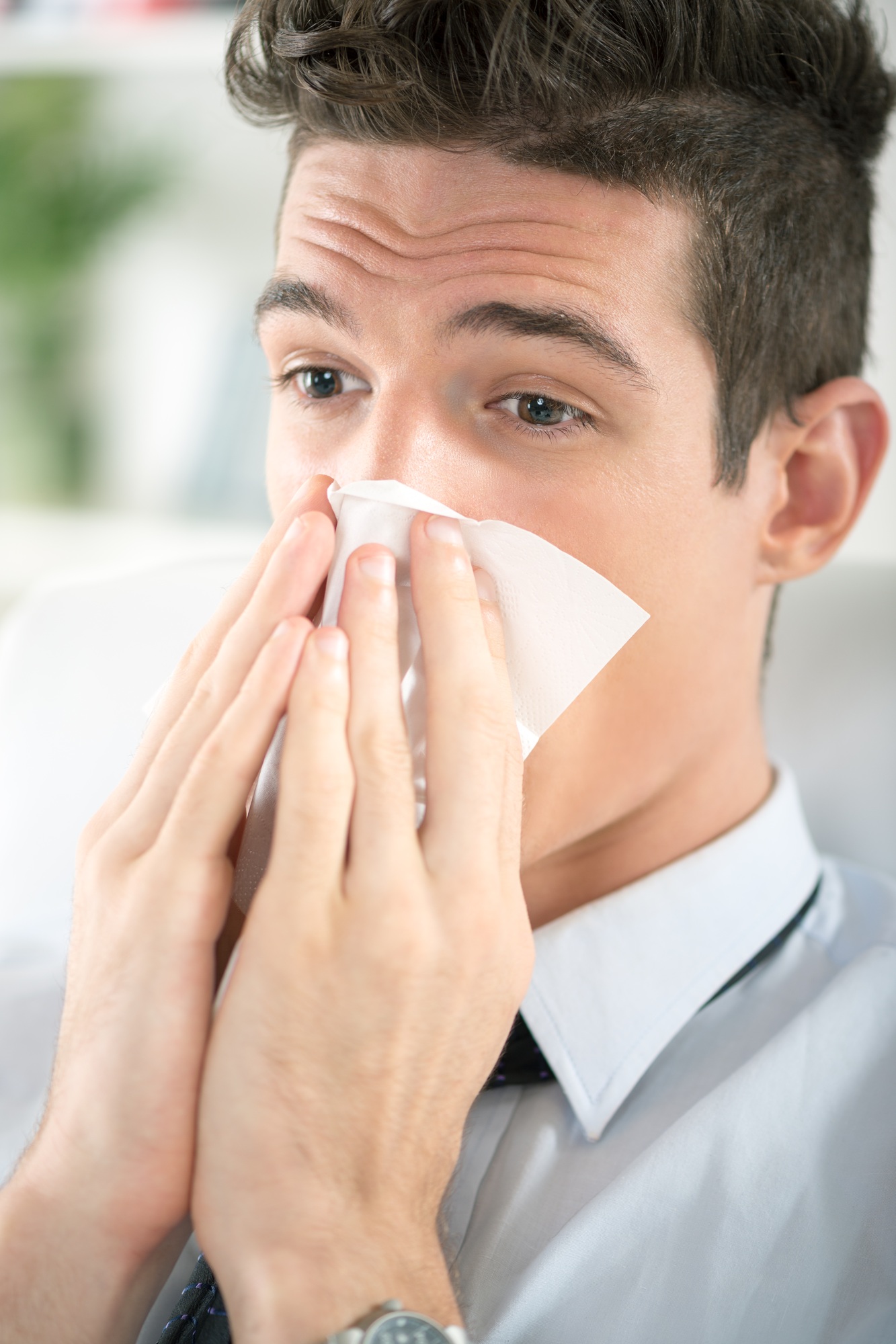 Person resting at home during a cold and flu telehealth visit