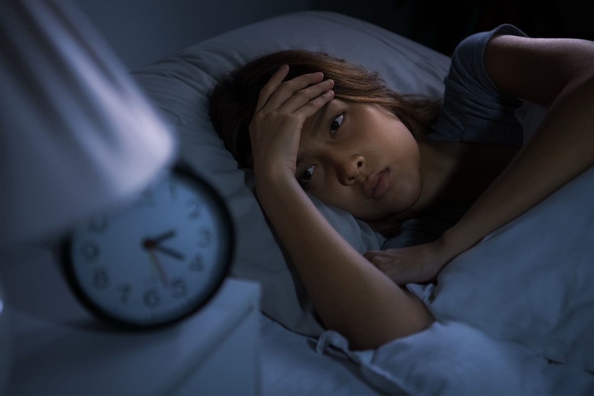 Person awake at night dealing with insomnia before a telehealth visit