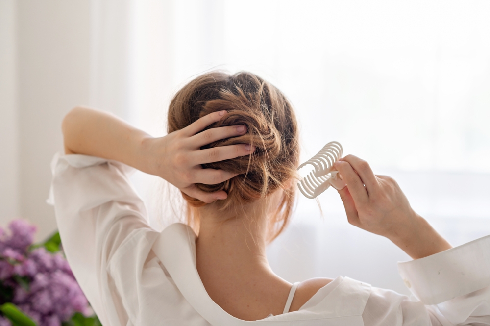 Parent checking a child’s hair for head lice before a telehealth visit