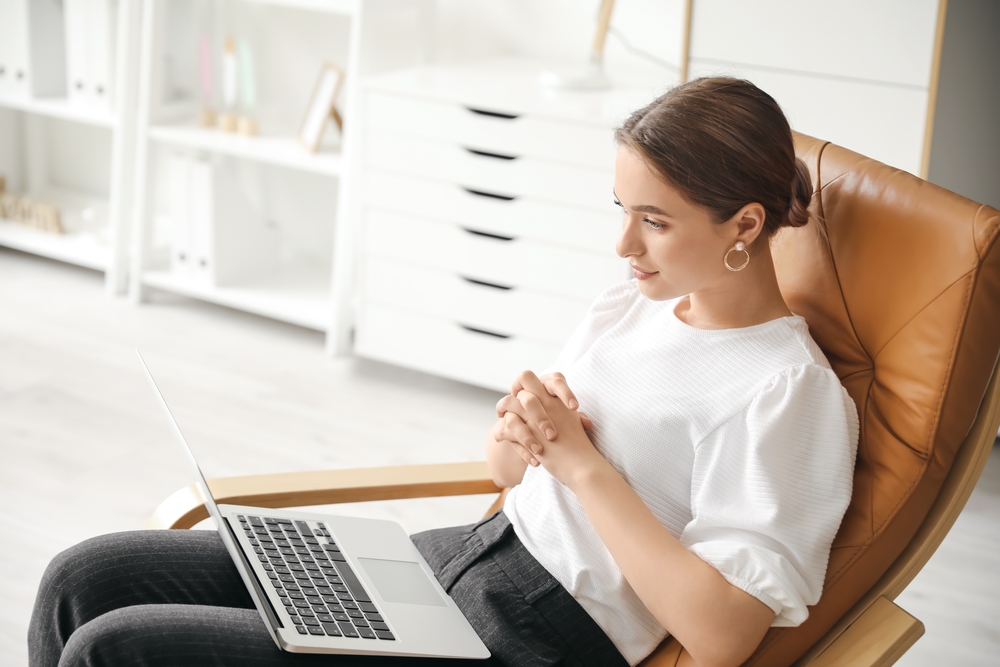 Psychologist working with patient online while sitting in office